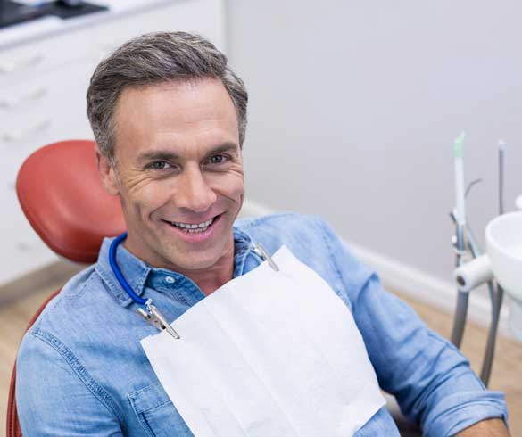 Man at Dentist for Teeth Cleaning